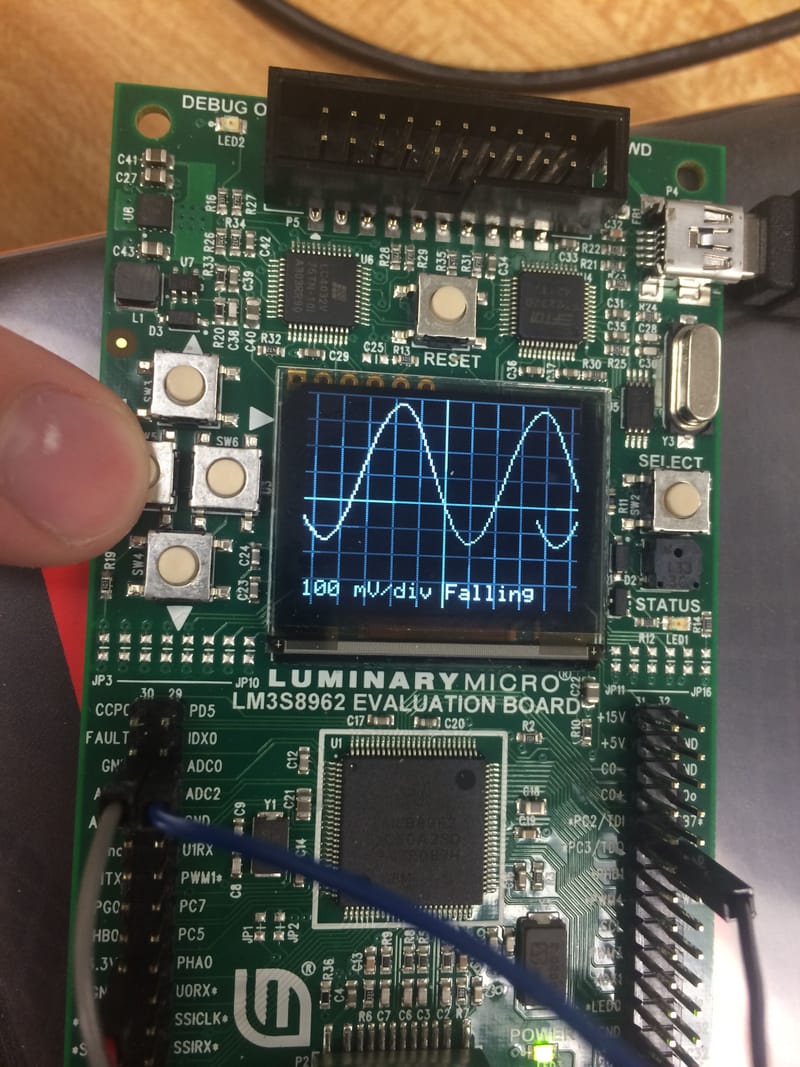 Note the Trigger (COSINE). Changing the Voltage Resolution (Scale).
Display shows waveform adjusted accordingly.