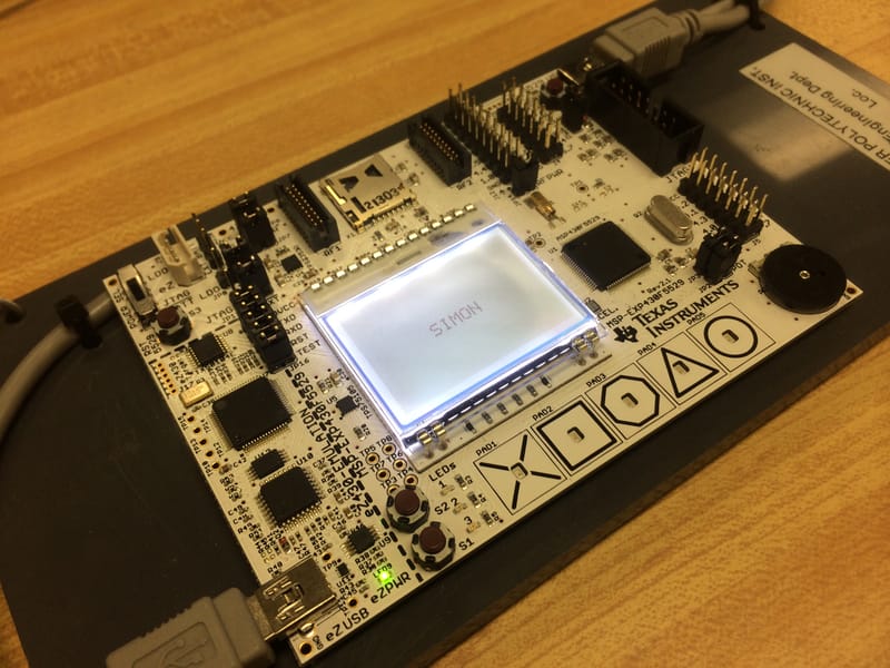The title screen of our Simon game displaying the X, Square, Octagon, Triangle, and Circle keys on the dot-matrix LCD.