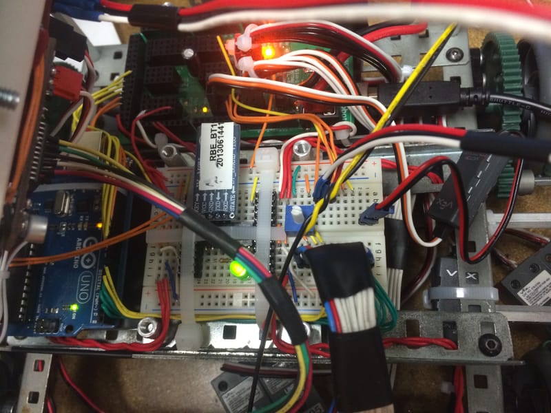 Nearly every row of the breadboard in use — Arduino, H-bridge, Bluetooth, and controller receiver.