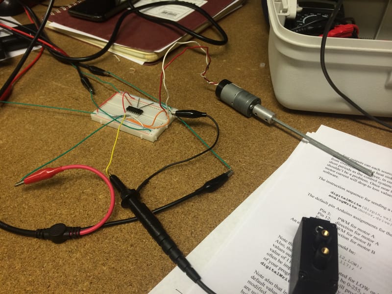 H-bridge motor driver on a breadboard with a geared motor.