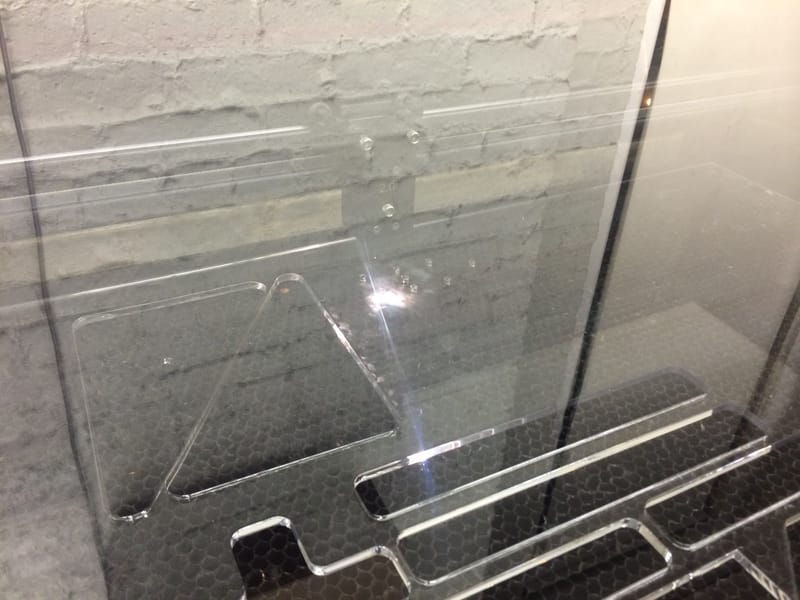 Laser cutter in action on 1/4" acrylic panels.