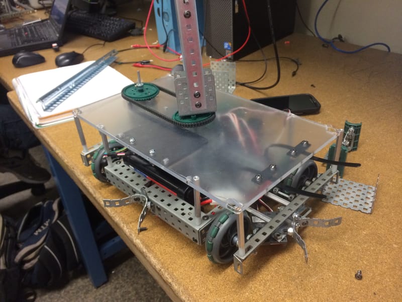 Top plate installed with battery zip ties, sprockets, and chains.