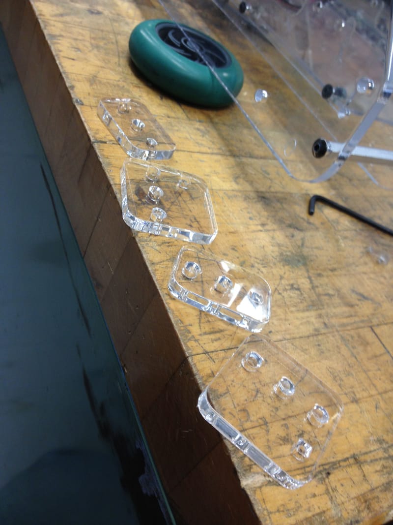 Laser-cut acrylic components with slotted joints for the all-acrylic chassis.